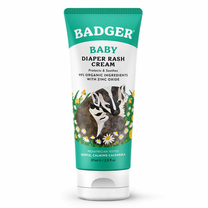A green tube of Badger Balm Diaper Cream features a badger among daisies, highlighting 99% organic ingredients with non-nano zinc oxide and soothing organic calendula, all pediatrician tested. The tube contains 2.9 fl oz.