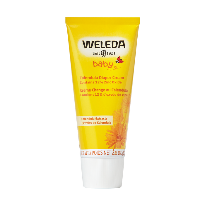 A yellow tube of Weleda Diaper Cream with a white cap features baby, Seit 1921, and product details, alongside a calendula flower image at the bottom. Its 2.8 oz / 81 g, part of Calendula Baby Care, and eligible for TerraCycle recycling.