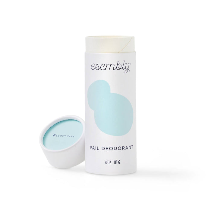 A white and blue 4 oz (113 g) container of Esembly Baby Diaper Pail Odor Eliminator & Deodorizer, labeled cloth safe, stands upright with the cap beside it. This all-natural powder is perfect for effectively deodorizing diaper pails.