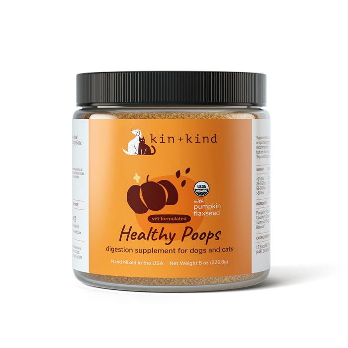 A jar of kin+kind Digestive Support Powder Supplement for Dogs and Cats, featuring an orange label with a pumpkin graphic. It contains prebiotic fiber, pumpkin, flaxseed, digestive enzymes, and is vet-formulated. Net weight: 8 oz (226.8g).