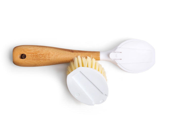 A versatile cleaning tool, the wooden-handled dish brush with beige bristles comes with two interchangeable white replacement heads. The handle, engraved with Grove Co., is showcased against a plain white background.