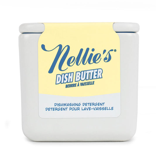 A square, white tub with a yellow and blue label reads "Nellie's Dish Butter" in English and French. This closed-lid container offers a zero-waste, convenient green cleaning solution for dishwashing.