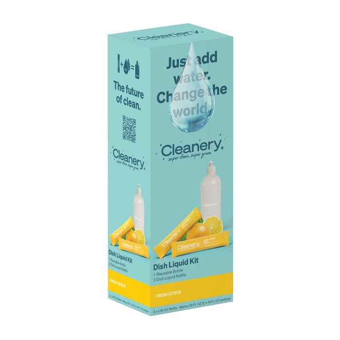 The Cleanery Dish Liquid Starter Kit packaging showcases a blue box with a droplet icon. The text reads, Just add water. Change the world. It includes a reusable bottle and two citrus-adorned eco-friendly refills, highlighting its sustainable dishwashing solution.