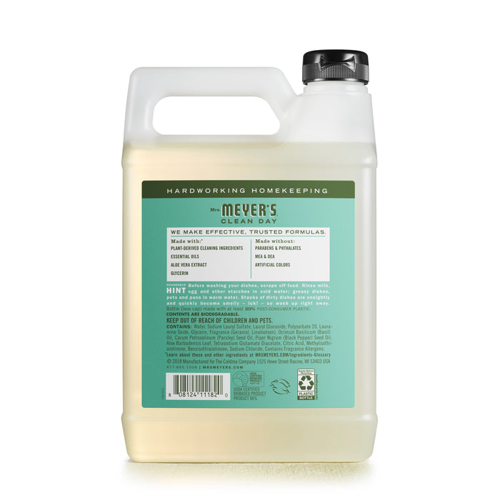 Mrs. Meyers Dish Soap Refill, in a simple green and white plastic container with a handle and spout, features a cruelty-free formula. The label offers usage instructions, ingredients, and warnings, reflecting its natural cleaning agents through its functional design.