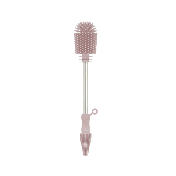 The Haakaa Double-Ended Silicone Cleaning & Bottle Brush, a baby gear must-have, has a pink design with textured bristles on both ends; one end features a spherical brush head while the other has a narrow pointed tip for precise cleaning.