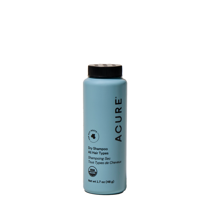 Acure Dry Shampoo, for all hair types, comes in a 1.7 oz light blue bottle with a black cap and text. This waterless formula absorbs hair oil and features both English and French labeling.