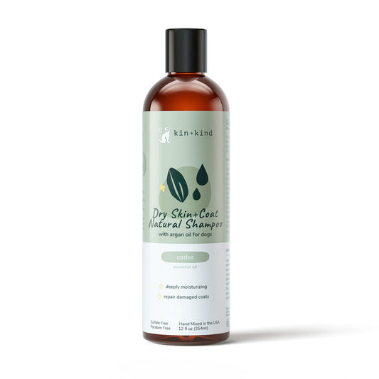 The kin+kind Dry Skin & Coat Dog Shampoo is expertly crafted with argan oil, featuring a label with leaves and droplets. It emphasizes cedar essential oil’s benefits like moisturizing and repairing damaged coats, making it an ideal choice for natural pet care.