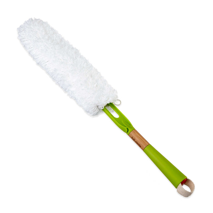 Introducing the Dust Whisperer Filament Microfiber Duster by Full Circle: a chic brush with a green plastic handle, wooden section, and white microfiber head. This washable duster features a fabric loop for hanging, making it perfect for effortless cleaning.