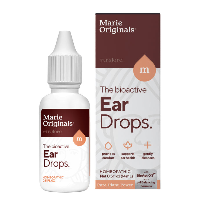 A white bottle and box of Marie Originals Ear Pain Relief Drops feature brown and white labeling, highlighting ear pain relief, comfort, ear health support, and gentle cleansing with a homeopathic, plant-based formula.
