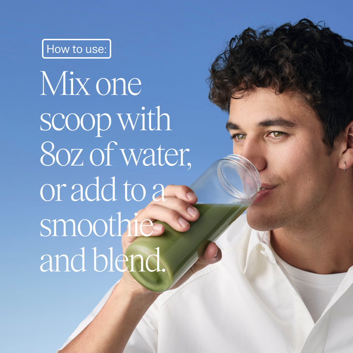 A young man in a white shirt drinks a green beverage made with Ora Organic’s Easy Being Green: Daily Active Superfood Greens Powder. Text reads: Mix one scoop with 8oz water or add to a smoothie. The background is clear blue.