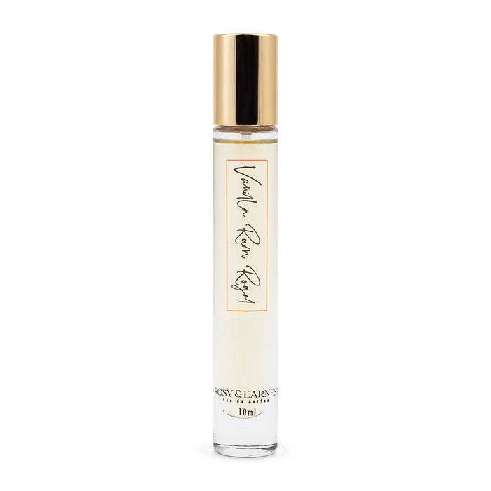 The Vanilla Rum Royal perfume by Rosy & Earnest comes in a simple, elegant cylindrical bottle with a 10ml capacity, featuring a light-hued liquid and a gold cap for a premium experience.