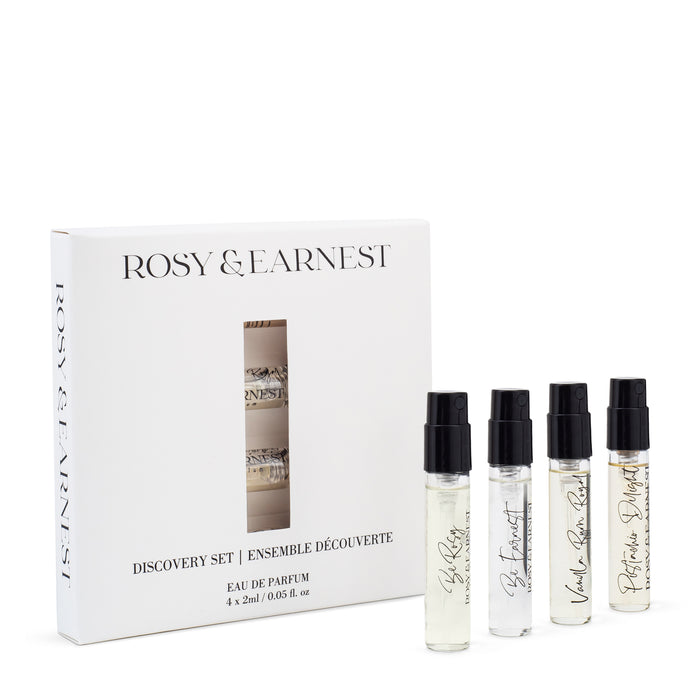 The Rosy & Earnest Discovery Set includes four 2ml perfume sprays in a white box with black brand and product details, promising an indulgent olfactory journey with rich notes of rum and pistachio.