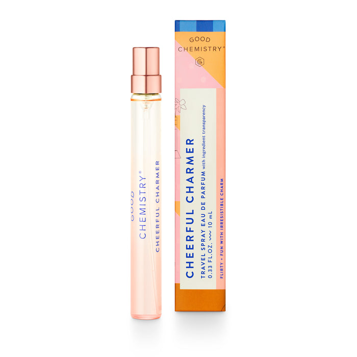A slender glass bottle labeled Eau De Parfum Travel Spray by Good Chemistry sits beside its vibrant box, adorned with orange, pink, and blue floral designs. This travel spray rollerball contains a delightful perfume perfect for on-the-go freshness.