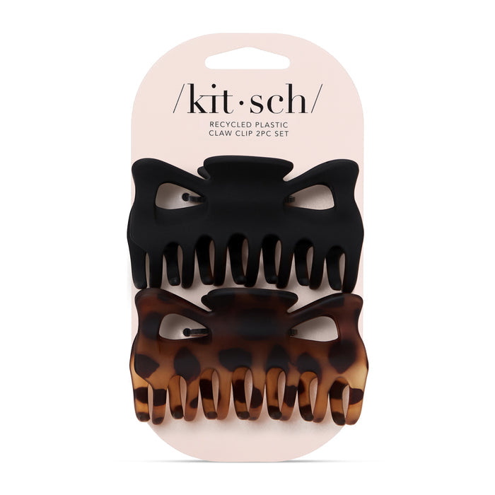 The packaging contains two Eco-Friendly Large Claw Clips by Kitsch, both made of recycled materials. The top clip is solid black, and the bottom features a tortoiseshell pattern, helping to reduce plastic waste. The brand name kit•sch is prominently displayed on the top of the packaging.
