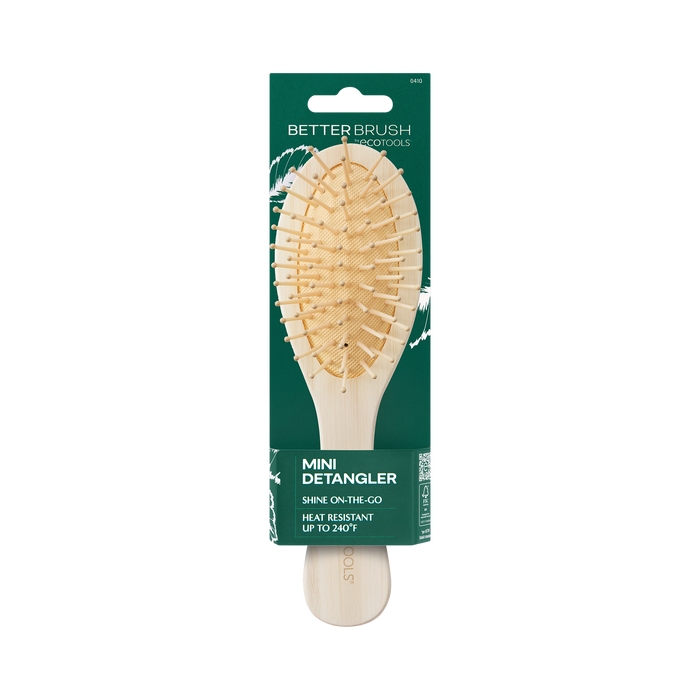 The EcoTools Eco Mini Shine Brush is a 100% bamboo travel-size paddle brush with multiple bristles, a curved shape, and heat resistance up to 240°F. It comes on green cardboard packaging reading Better Brush, Protools, Mini Detangler, Shine On-The-Go.