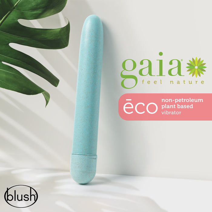 A blue eco-friendly, non-petroleum plant-based vibrator is placed against a light background with a green leaf. The text reads "gaia feel nature" and "éco non-petroleum plant based vibrator." The brand "blush" is in the corner.