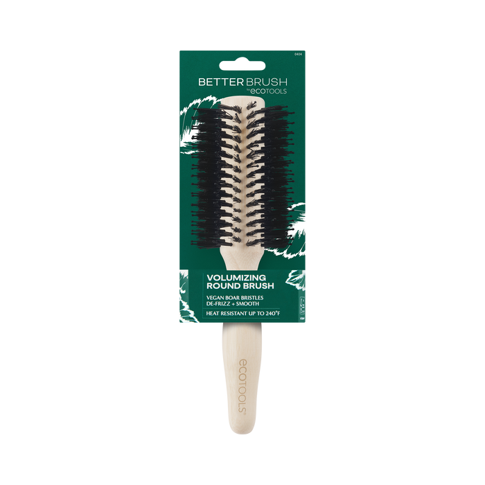 The EcoTools Eco Volumizing Round Brush has a light handle made from 100% renewable bamboo. Its green packaging with white leaf illustrations highlights vegan boar bristles and heat resistance up to 240°C.