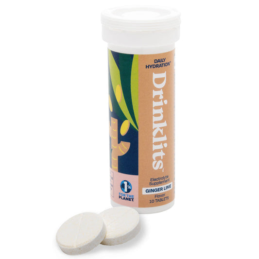The white cylindrical Drinklits tube labeled Electrolyte Hydration Tablets contains 10 zero-sugar tablets with a ginger lime flavor, featuring essential electrolytes. Ginger root graphics adorn the package, with two tablet discs displayed beside it.