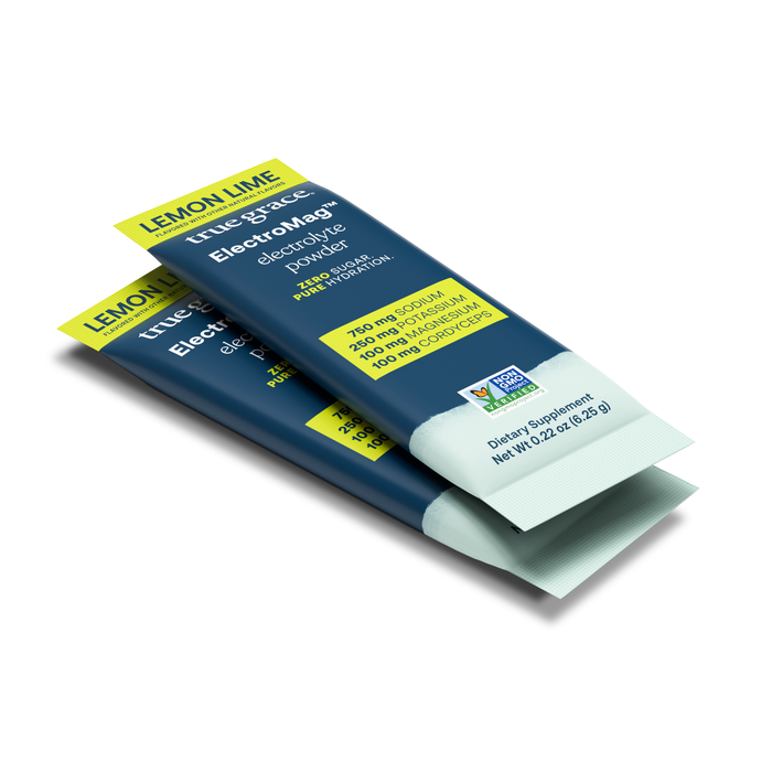 Two packets of True Graces ElectroMag™ Electrolyte Powder in Lemon Lime flavor are perfect for hydration. Each 0.2 oz blue and white packet displays Organic Paleo and Non-GMO Verified labels, showcasing supplement facts and certifications.