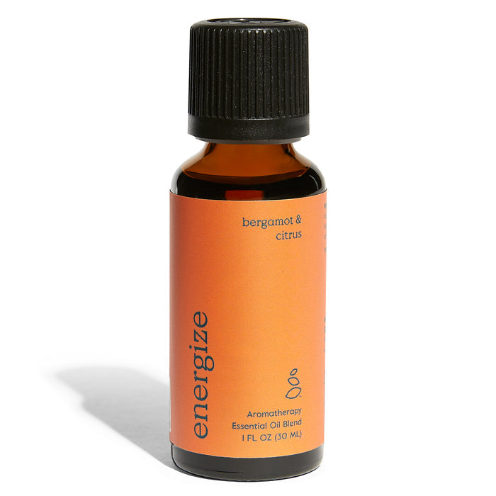 A 1 fl oz amber bottle by Grove Co. labeled in lowercase as energize with a black cap features an orange label saying bergamot & citrus containing an organic essential oil blend for aromatherapy.