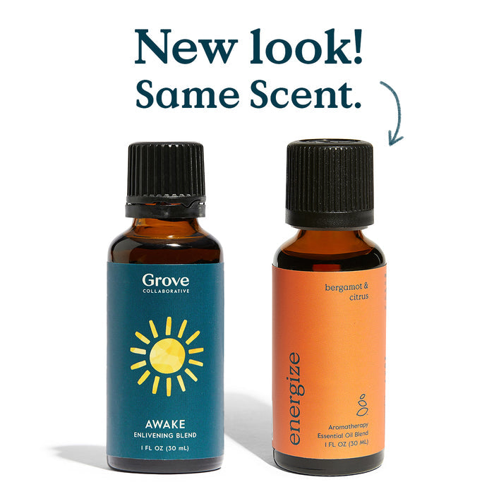 Two brown bottles with black caps: the left is labeled Grove Co. Energize featuring a sun graphic, while the right reads bergamot & citrus energize, ideal for aromatherapy. Text above says, New look! Same scent.