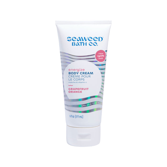 A 6 fl oz tube of The Seaweed Bath Co. Energizing Body Cream, featuring matcha and a Grapefruit and Orange scent, has a wave pattern label with English and French text, plus a new uplift look circle.