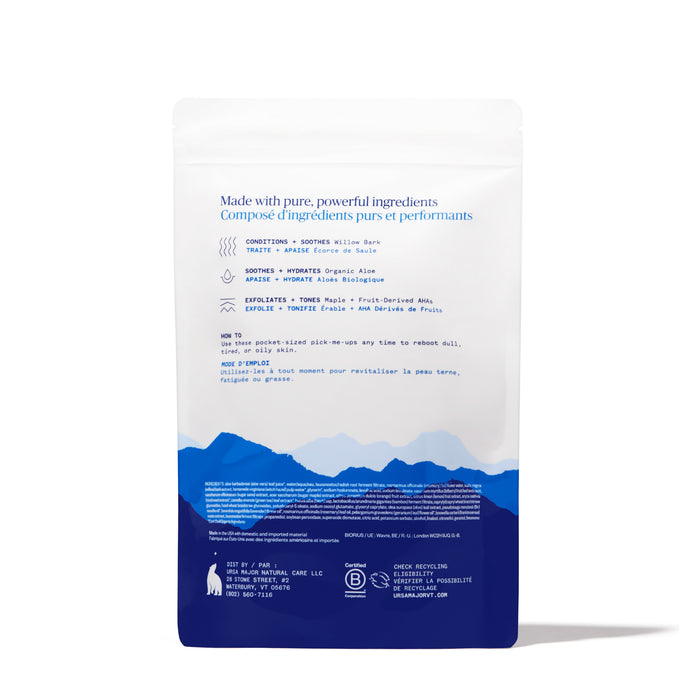 Ursa Major Essential Face Wipes come in a white and blue resealable bag with a mountain silhouette. The back label lists clean ingredients and benefits in English and French, using blue text.
