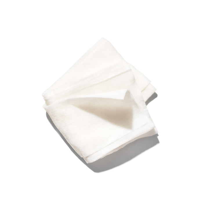 A stack of Ursa Major Essential Face Wipes, individually wrapped, displayed folded on a white background with a shadow underneath.