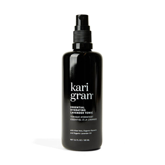 The black Kari Gran Essential Hydrating Tonic spray bottle rehydrates skin and maintains the moisture barrier. It contains aloe vera, organic glycerin, and organic lavender oil. The bottle size is 3.4 fl. oz (100 ml).