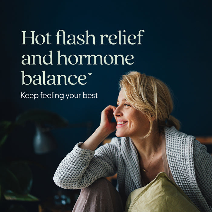 A smiling blonde woman sits indoors, head resting on her hand. Text: New Chapter Estrotone™ Herbal Hormone Balance for pre & post menopause—supports hot flash relief and hormone balance. Dark background adds a calm, cozy feel.