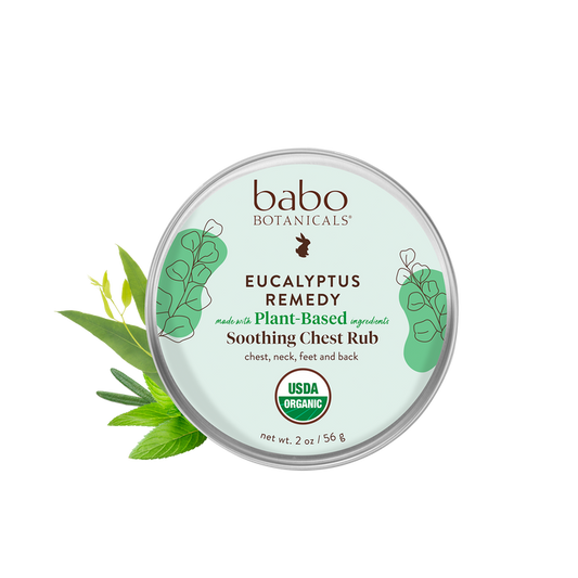 A round tin labeled Eucalyptus Remedy Organic Soothing Chest Rub by Babo Botanicals features plant illustrations. Its ideal for use on the chest, neck, feet, and back as a baby chest rub. Made with Plant-Based Ingredients and USDA Organic, it has a net weight of 2 oz/56 g.