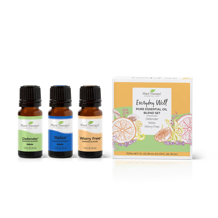 Three bottles of Plant Therapys Everyday Well Pure Essential Oil Blend Trio labeled Defender, Relax, and Worry Free rest alongside a citrus-themed box, offering tranquility and an immune boost with this exquisite collection.