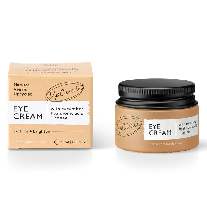 The 15ml UpCircle Eye Cream in a jar with a black lid, and its beige box labeled Natural. Vegan. Upcycled, promise to reduce puffiness and dark circles with cucumber, hyaluronic acid, and coffee.