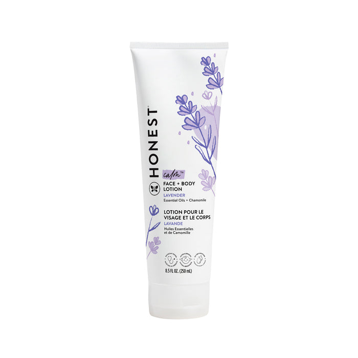A white tube of The Honest Companys Face + Body Lotion, with naturally derived lavender and chamomile ingredients. It features lavender illustrations and a bilingual English/French label. Suitable for all skin types, the 8.5 fl oz (250 ml) lotion is perfect for your skincare routine.