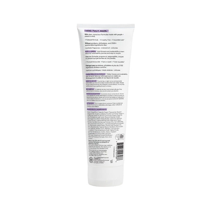 The image features the back of a white Face + Body Lotion by The Honest Company. It has purple and black text detailing naturally derived ingredients, ideal for all skin types. The tube stands upright against a plain white background.