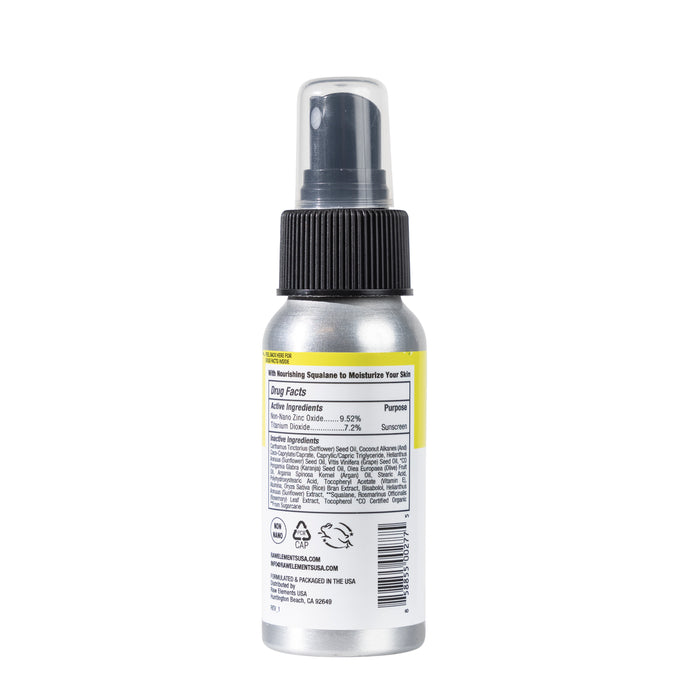 A silver Raw Elements Face & Body Spray bottle with a black cap and nozzle highlights Drug Facts for active ingredients and uses. The label promotes broad spectrum SPF 50 protection with Titanium Dioxide Mineral Sunscreen. Recycling symbols and manufacturing details are on the bottom, ideal for moisturizing skin.