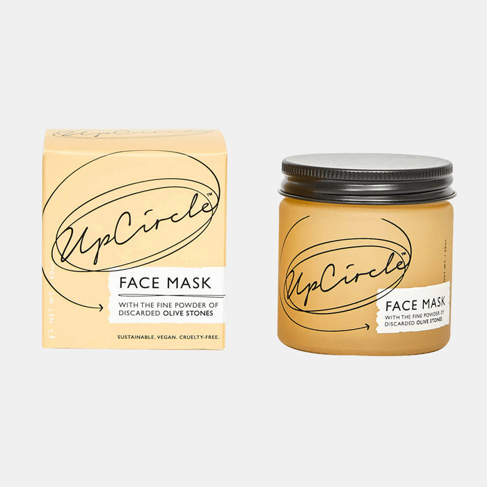 An image shows the UpCircle Face Mask with Kaolin Clay, featuring a jar and its light yellow package with black text. This sustainable, vegan, and cruelty-free product is enriched with nourishing olive stones and purifying kaolin clay.