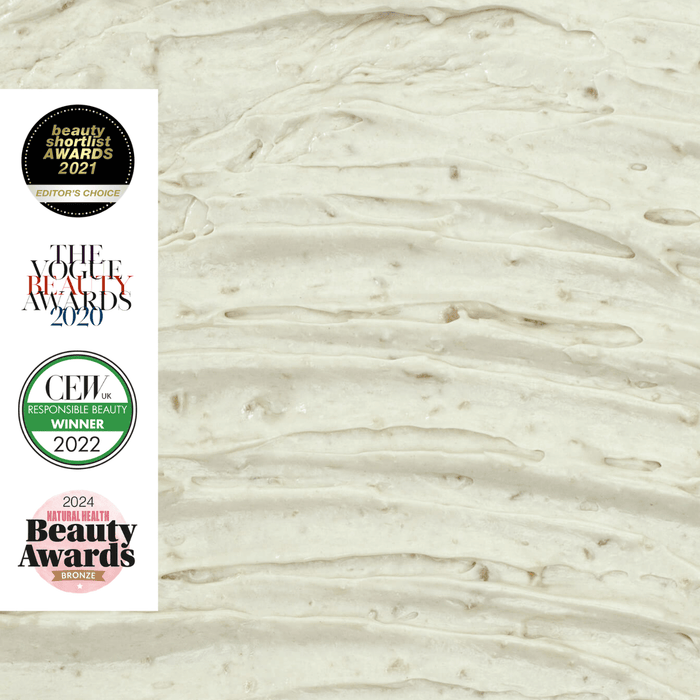 Close-up of a creamy textured background with four award logos on the left: Beauty Shortlist Awards 2021, The Vogue Beauty Awards 2020, CEW Responsible Beauty Winner 2022, and 2024 Natural Health Beauty Awards Bronze.