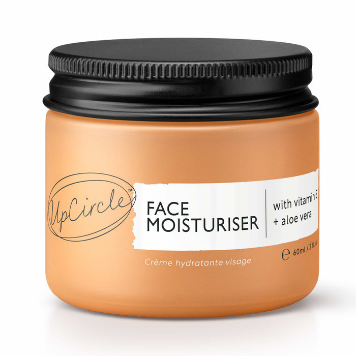 The UpCircle Face Moisturizer with Vitamin E + Aloe Vera comes in a beige 60ml (2.1 fl oz) jar with a black lid, featuring labels with vitamin E-rich argan powder and aloe vera and Crème hydratante visage.