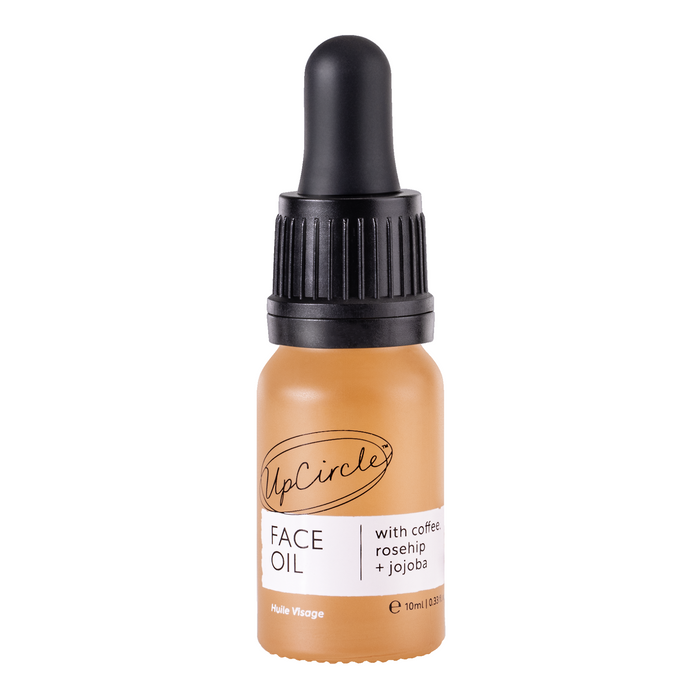 A 10 ml UpCircle Face Oil features a black dropper cap, promoting collagen with the nourishing properties of coffee, rosehip, and jojoba for vibrant skin.