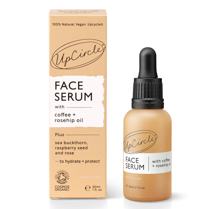 An UpCircle Face Oil with Coffee, Rosehip + Jojoba is pictured beside its packaging. The label emphasizes ingredients like coffee and rosehip for collagen boost, plus sea buckthorn, raspberry seed, and rose for hydration and protection.