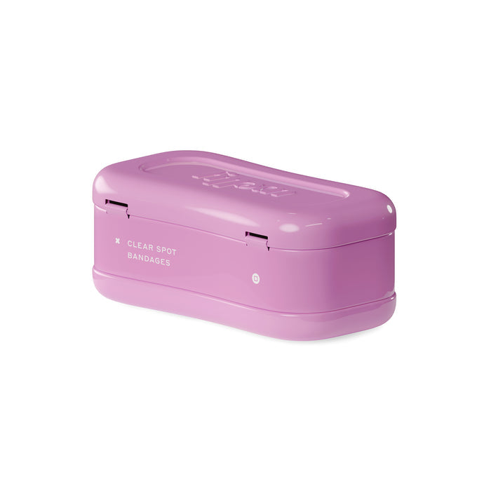 The Face Saver by Welly is a pink rectangular tin with a hinged lid, designed to discreetly cover blemishes and provide spot bandage protection.