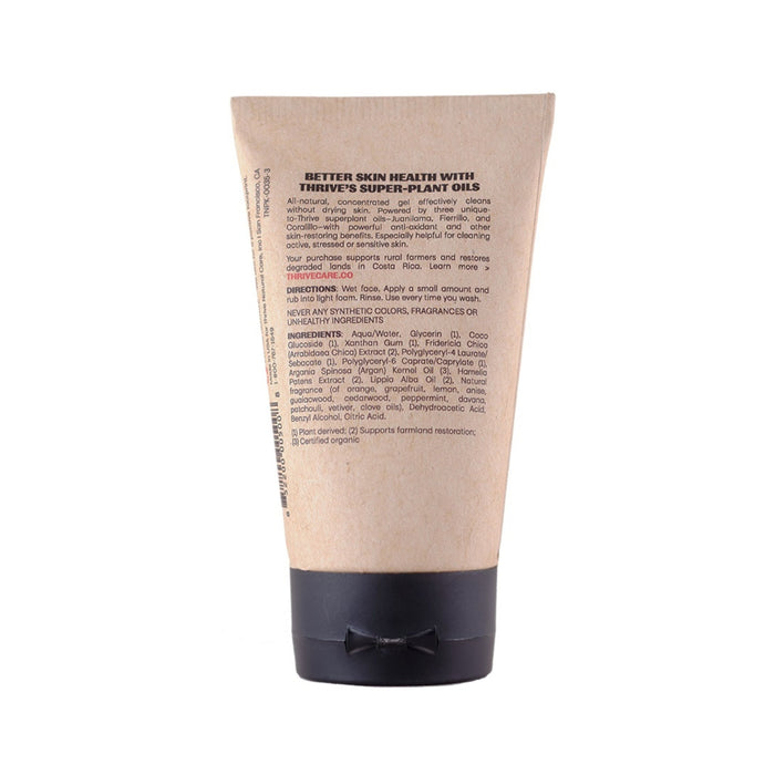 Thrive Natural Cares Face Wash comes in a tan tube with a black cap, featuring text on regenerative plant ingredients like Aloe Barbadensis and Acai for skin health. The minimalistic design stands out against a plain white background.