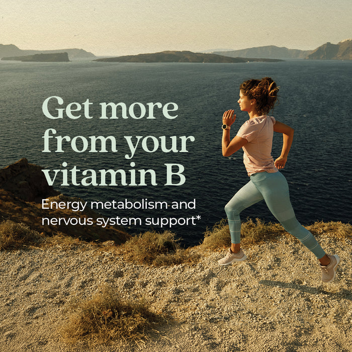 A woman in athletic wear runs along a rocky coast with sea and mountains behind her. Overlaid text: New Chapter Fermented Coenzyme B Complex—energy metabolism & nervous system support.*.