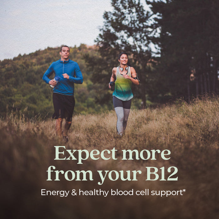 A man and woman jog through a grassy field with trees. Text reads: New Chapter Fermented Vitamin B12—For Cellular Energy + Healthy Blood Cells.*.