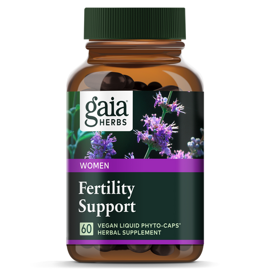 A Gaia Herbs Fertility Support brown bottle with purple flowers on a black background contains 60 vegan liquid phyto-caps, designed to support hormone levels and nurture natural ovulation rhythm.