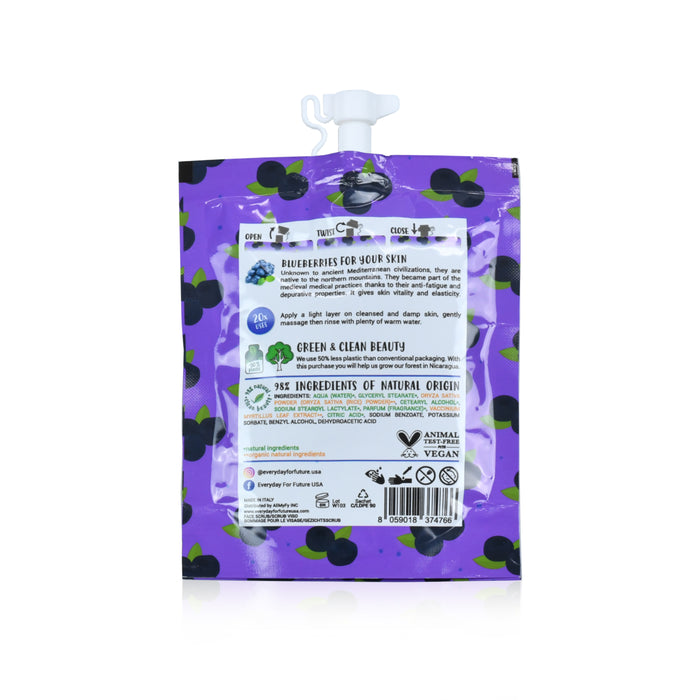 Everyday For Futures Face Scrub comes in a purple pouch adorned with black polka dots and blueberries. It features natural ingredients, a vegan certification, icons for environmental benefits and antioxidant properties, and is equipped with a white spout. Perfect for your skincare routine!.