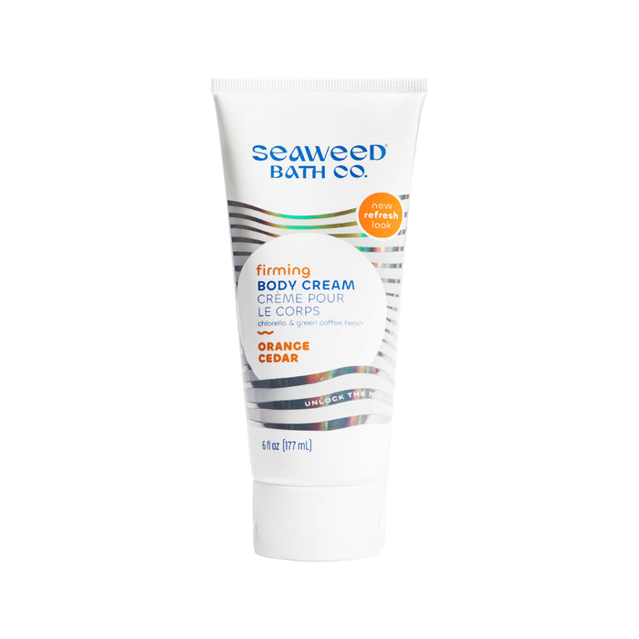 A 6 fl oz (177 ml) tube of The Seaweed Bath Co.s Firming Body Cream, scented with orange and cedar. Infused with bladderwrack seaweed, the label highlights product details and features a now refreshed look badge.