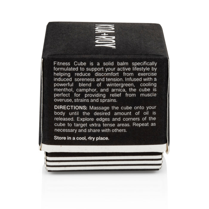 The black and white Fitness Cube by KOA + ROY is a balm for muscle recovery, soothing post-exercise discomfort with plant-based ingredients including wintergreen, menthol, camphor, and arnica. Clear directions for use and storage are provided.