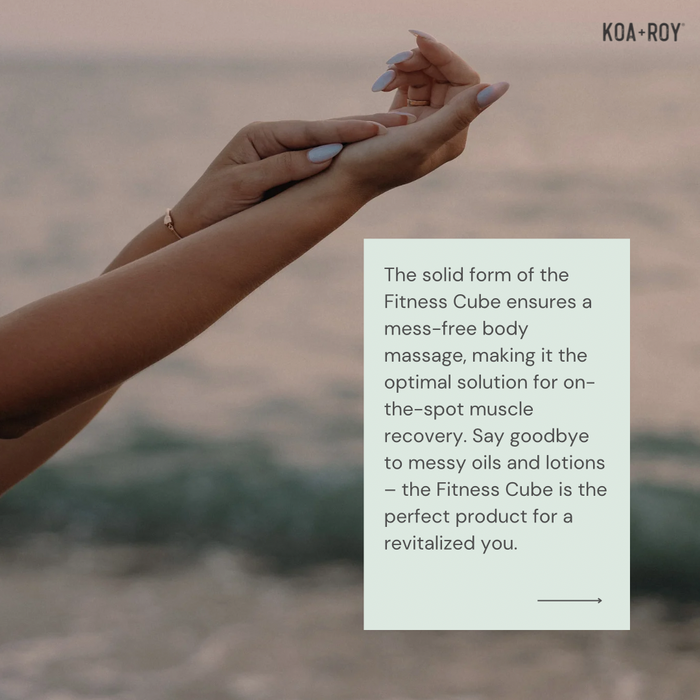 At sunset by the sea, a person with manicured nails massages their forearm using KOA + ROYs Fitness Cube—a solid, mess-free product made with plant-based ingredients for muscle recovery and body massage that leaves you feeling revitalized.